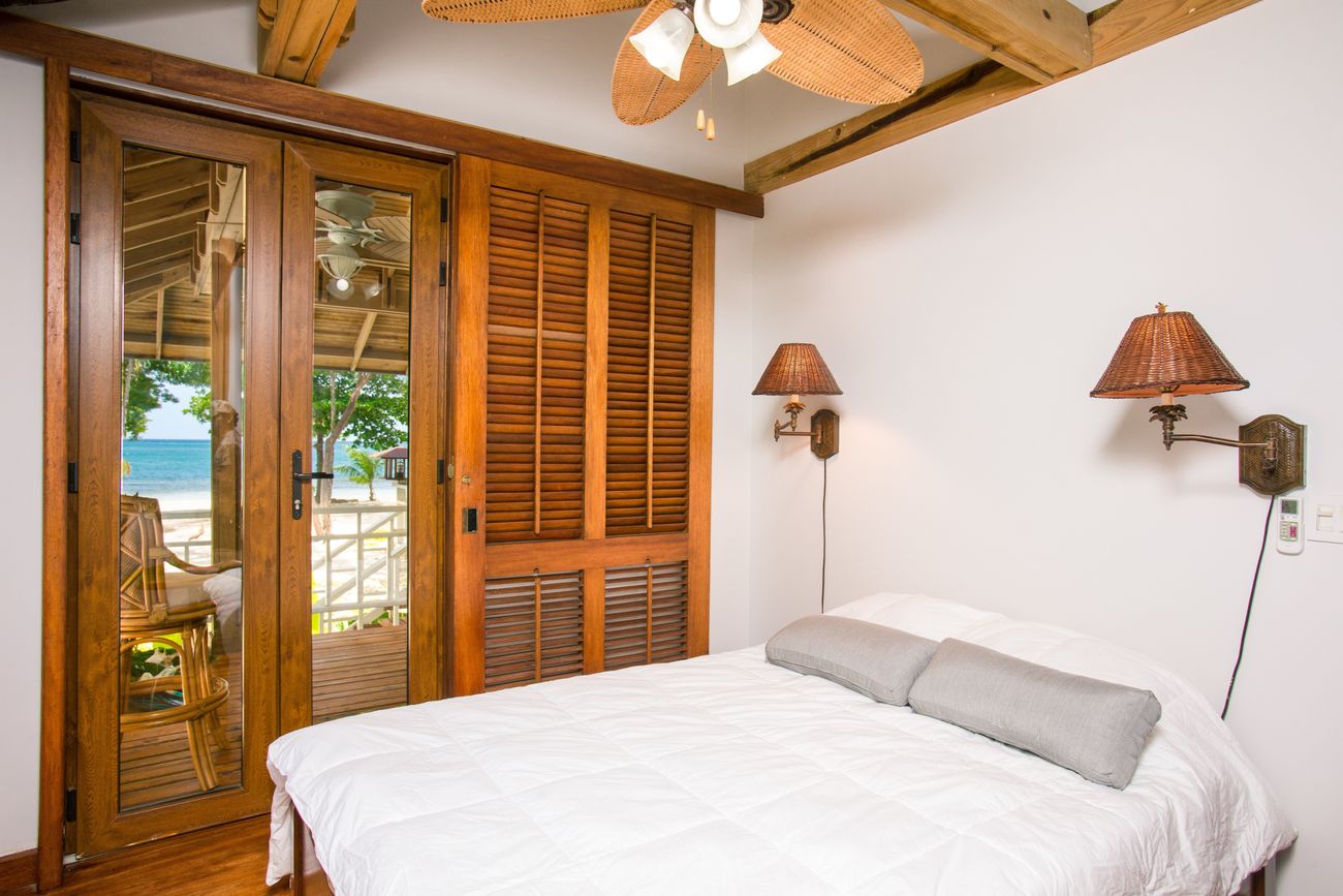 Hotel bedroom with timber shutters and a light, relaxed interior
